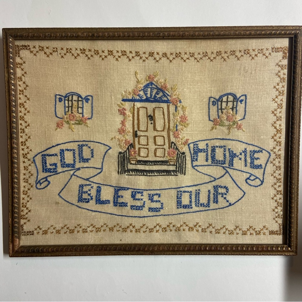 Antique embroidered wall art with original frame.